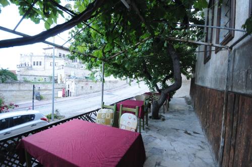a table with a red table cloth on a street at Born Hotel in Urgup