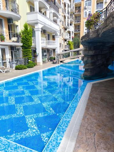 a swimming pool in a hotel with blue water at Two-bedroom apartment on the 6th floor in Sunny Beach