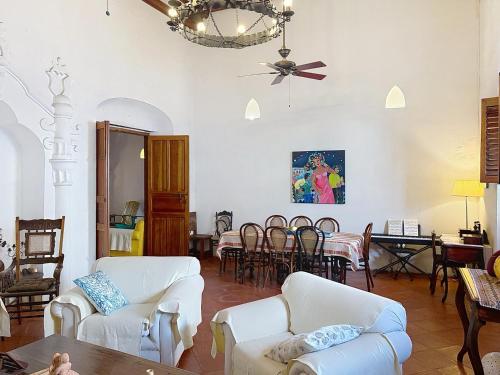 a living room with white furniture and a dining room at Casa Digna in Cartagena de Indias