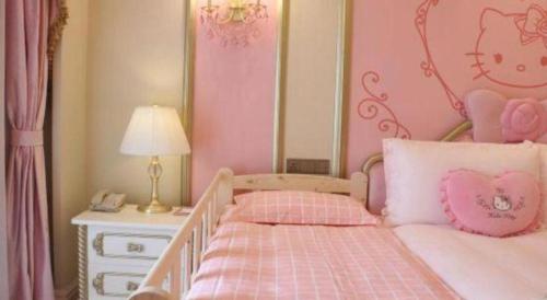 a pink bedroom with a bed and a night stand at Yin Run Jin Jiang Castle Hotel in Huzhou