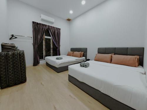 a living room with two beds and a couch at Private Pool KTV Family Villa 3R 12Pax by I Housing in Kampong Solok Haji Dollah