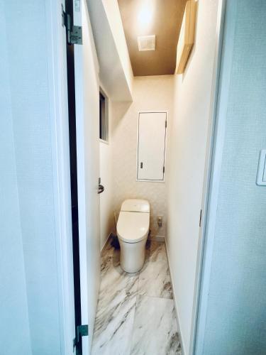 a bathroom with a toilet in a small room at Miyazaki in Tokyo