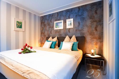 a bedroom with a large white bed with blue walls at Komfortables Appartement In Bad Kötzting Mit Eintritt In Die Bade Und Saunawelt in Bad Koetzting