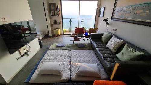 a living room with a couch and a large window at Calm Lux 3 BR 2 Baths next to AEON Mall in Cilandak
