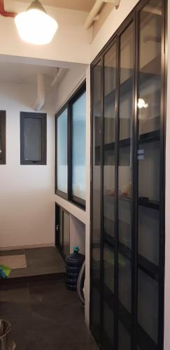a room with a large glass wall with a tv at Calm Lux 3 BR 2 Baths next to AEON Mall in Cilandak