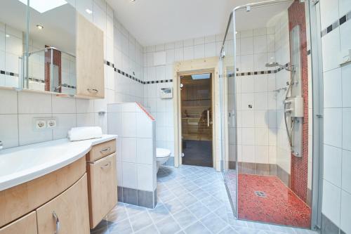 a bathroom with a shower and a toilet at Appartements Der Fuchsbau in Saalbach Hinterglemm