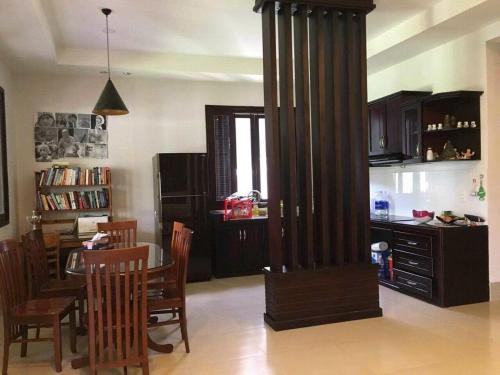 a living room with a large column in the middle of a room at Villa Nhà Như in Phu Quoc