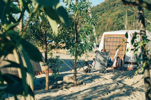 a tent and a chair next to a swimming pool at iwado base in Tottori