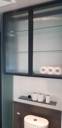 a window above a toilet in a bathroom at Calm Lux 3 BR 2 Baths next to AEON Mall in Cilandak