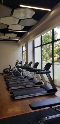 a row of treadmills in a gym with windows at Calm Lux 3 BR 2 Baths next to AEON Mall in Cilandak