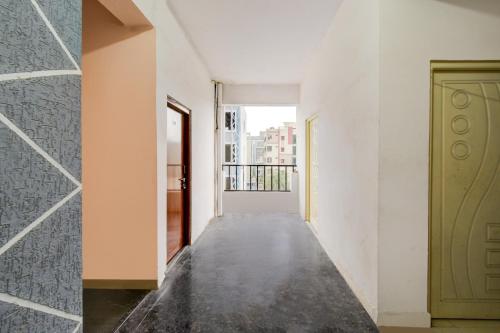 an empty corridor with a door and a hallway with a balcony at Super Hotel O Chandanagar Formerly Nakshatra in Lingampalli