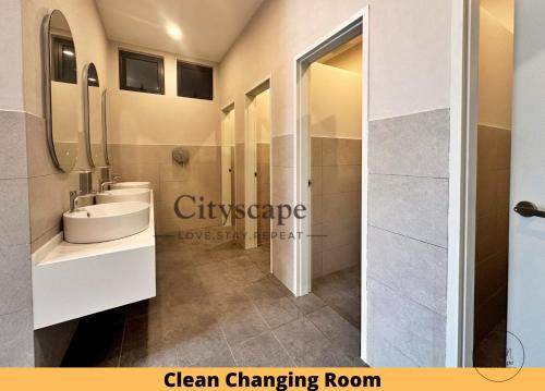 a bathroom with a white sink and a shower at Majestic Residence Kuala Lumpur by Cityscape in Kuala Lumpur