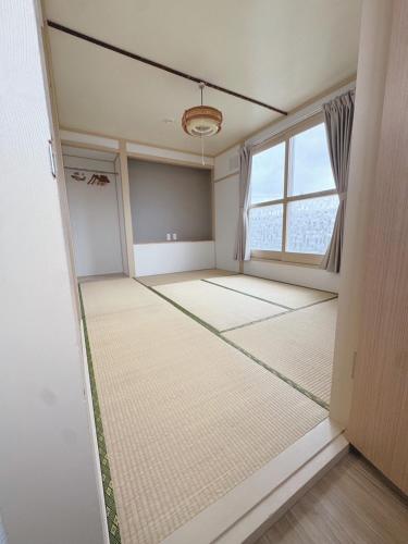 an empty room with a large window in a room at 白樺 Shirakaba in Yuni