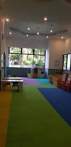 a room with a table and a green carpet at Calm Lux 3 BR 2 Baths next to AEON Mall in Cilandak