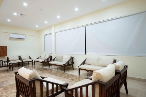 a waiting room with chairs and a large white screen at Treetop by Eight Continents, Zanzibar in Mchangani