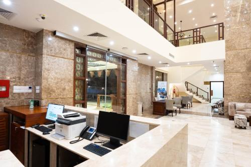an office with a desk with a computer on it at Treetop by Eight Continents, Zanzibar in Mchangani