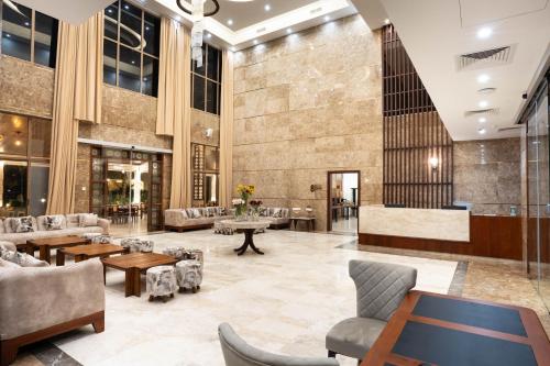 a lobby of a building with couches and tables at Treetop by Eight Continents, Zanzibar in Mchangani