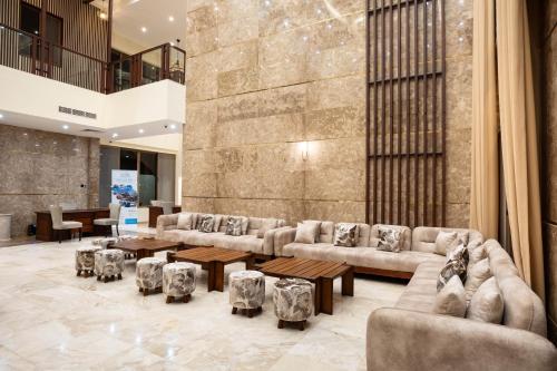 a lobby with couches and tables in a building at Treetop by Eight Continents, Zanzibar in Mchangani