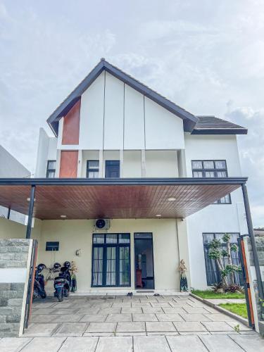 a building with motorcycles parked in front of it at Villa Asana Kolam Renang Private in Godean