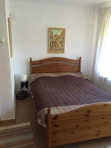 a bedroom with a wooden bed in a room at Dominic Boutique Tamplarilor in Sighişoara