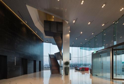 a lobby with a staircase in a building at Hotel ORA Incheon in Incheon