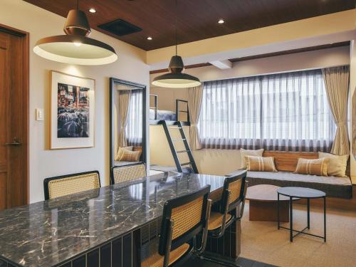 a kitchen and living room with a table and chairs at illi Mani Shibuya in Tokyo