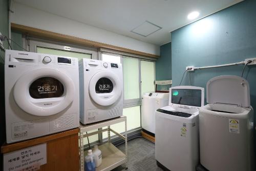 a hospital room with washing machines and a computer at JB Plus Hotel in Busan