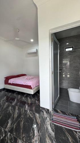 a bedroom with a bed and a bathroom with a shower at D'Villa Roomstay in Tangkak