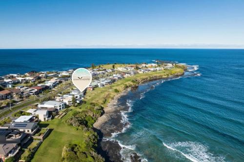a hot air balloon flying over the ocean at Amaroo in Gerroa