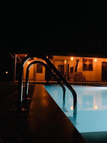 a swimming pool at night with a lit up swimming pooliterator at Aaryana Lagoon in Tangalle