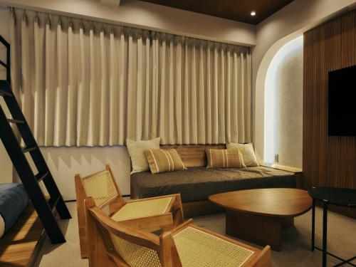 a living room with a couch and a table at illi Mani Shibuya in Tokyo