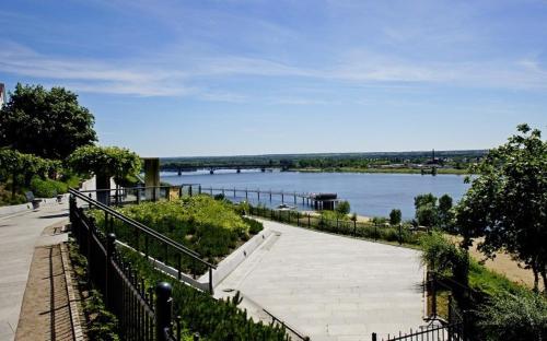 a view of a river with a bridge in the distance at Apartament Okrzei in Płock