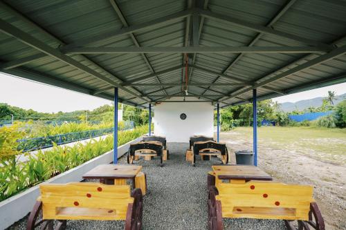 a group of tables and chairs in a pavilion at Ginadel Agritourism Park in Sampong