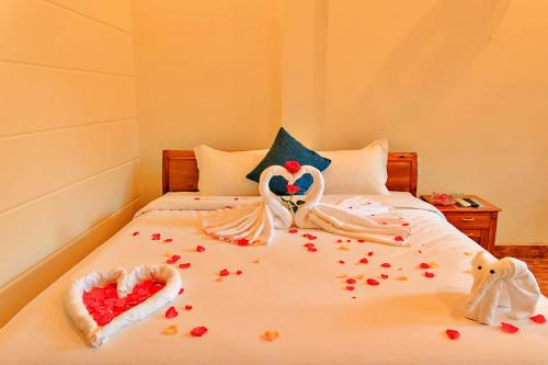 a bed with two swans made to look like hearts at S79 Blue in Phu Quoc