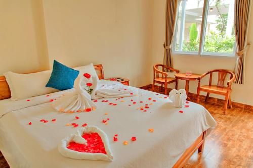 a bedroom with a bed with flowers on it at S79 Blue in Phu Quoc