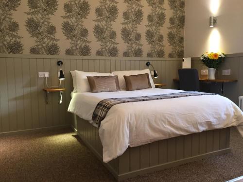 a bedroom with a large bed with white sheets at Irvine Bay in Irvine