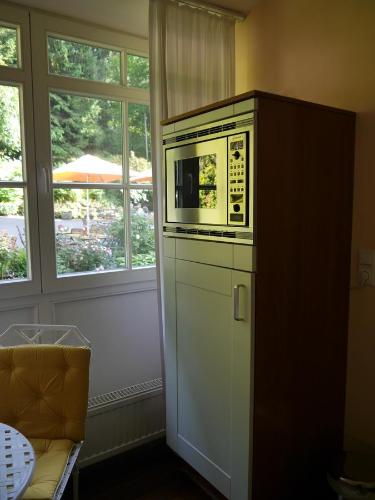 a microwave sitting on top of a cabinet in a kitchen at Haus Honigstal Landhaus Café in Wuppertal