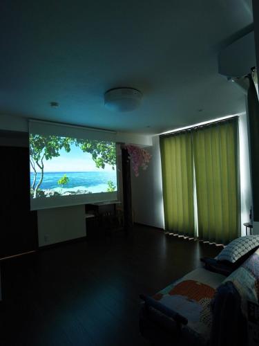 a bedroom with a large screen showing a beach at Newly built house in Ota Ward,6 minutes from the station in Tokyo