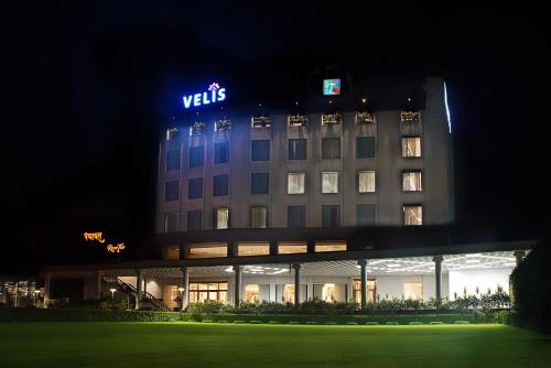 a hotel building with a lit up sign on it at TreeHouse Velis Sonipat in Sonīpat