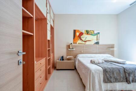 a bedroom with a bed and a dresser in it at Casa Castriota in Gallipoli