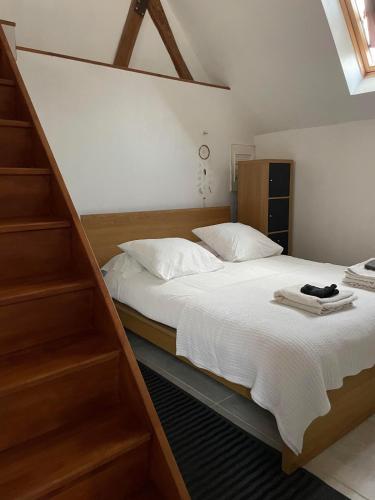 a bedroom with a large bed with wooden shelves at loft à la campagne in Vermenton