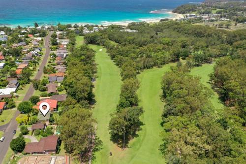 an overhead view of a golf course with the beach at Ocean & Golf in Mollymook