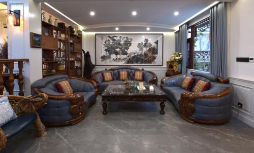 a living room with couches and a table at Dream in Fenghuang in Fenghuang