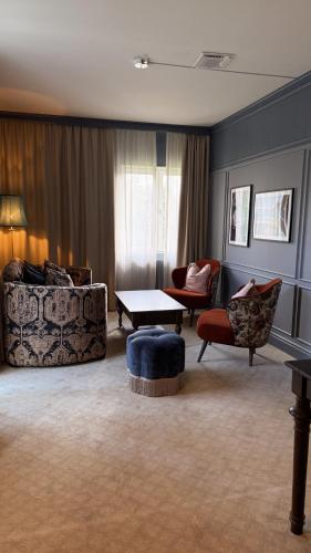 a living room with two couches and a table at Karstorp Säteri – Hotell och Konferens in Skövde