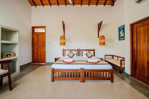 a bedroom with a bed and a couch in it at Serenity Boutique - Unawatuna in Unawatuna