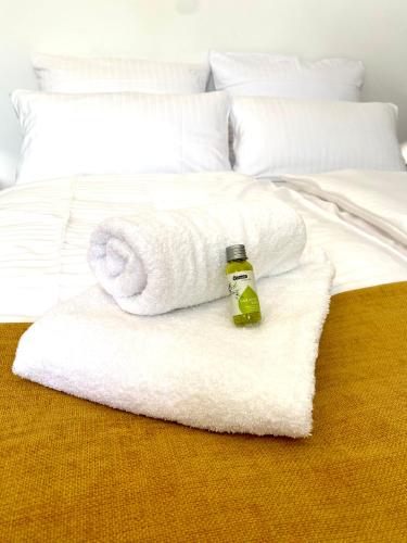 a white bed with a towel and a bottle on it at Apartmentkombi Eltville für bis zu 8 Personen in Eltville