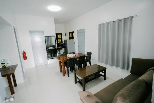 a living room with a couch and a table at Ginadel Agritourism Park in Sampong