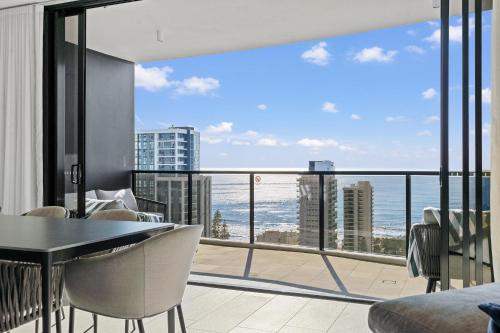 a room with a balcony with a view of the ocean at Encore Broadbeach - Official in Gold Coast