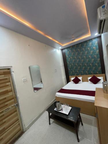 a hotel room with a bed and a table at kashi vishweshwar home stay in Varanasi