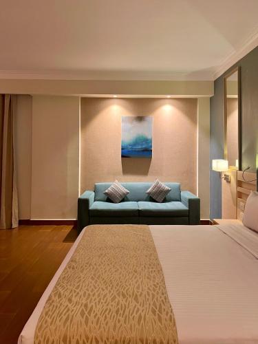a hotel room with a bed and a couch at Xanadu Makadi Bay - High Class All Inclusive in Hurghada
